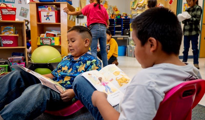 Students reading books together.