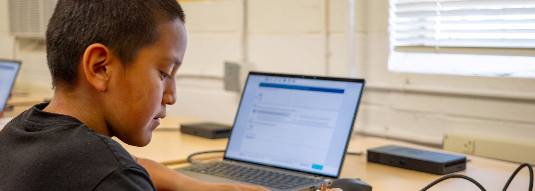 Male student working on laptop.