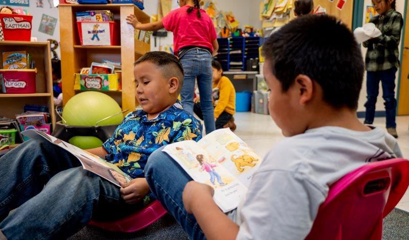 Students reading books together.